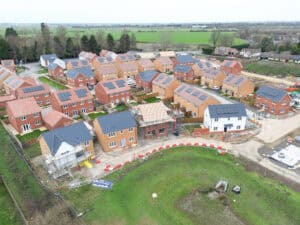 Aerial view of a new housing development under construction, the kind of major scheme the CIRIA SuDS Manual (C753) guides drainage design for.