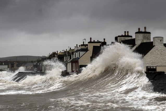 Waves crashing into coastal homes