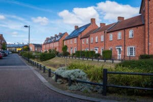 Sustainable drainage swale beside new-build housing, the kind of major scheme a lead local flood authority reviews.