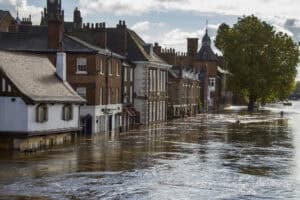 Floodwater covering a historic riverside street, the kind of event the Flood and Water Management Act 2010 was written to answer.