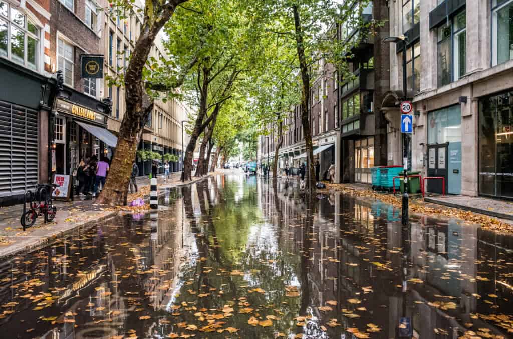 Store Street in Central London is flooded after torrential rain, a break from the heatwave of August 2022.