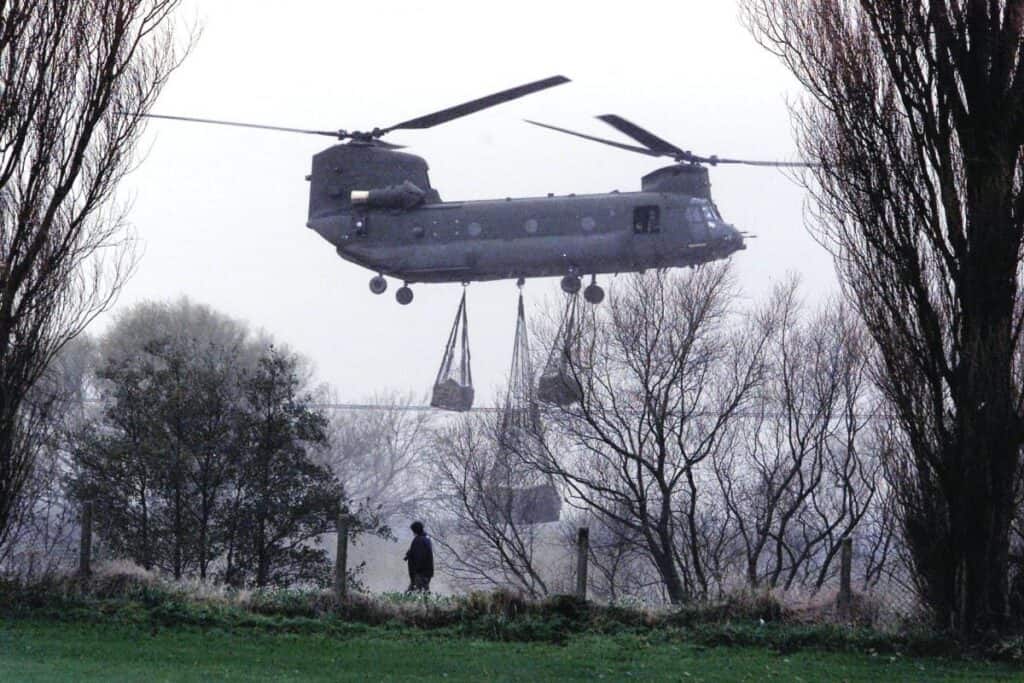 An RAF Chinook helicopter delivers sandbags to shore up defences