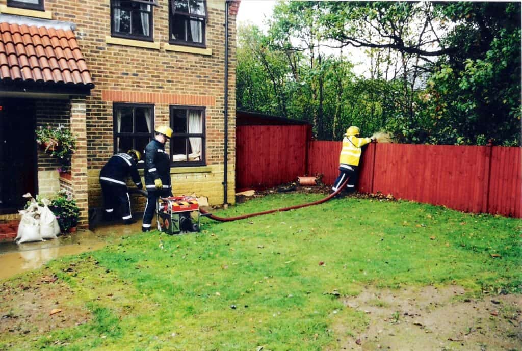 Firefighters pump water out of flooded homes in Maidenbower, Crawley