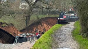 The Whitchurch canal breach on the Llangollen Canal, with the embankment collapsed and a narrowboat dropped into the void.