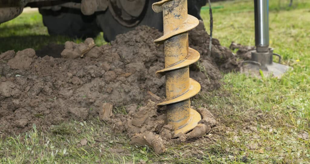 A mini drilling rig beginning to drill a borehole