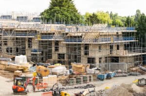 Residential development under construction in scaffolding, the kind of new-build scheme a BREEAM flood risk assessment supports.