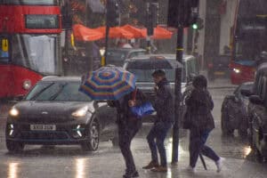 Heavy rain on an urban street, illustrating surface water flooding pressures relevant to forecasting and planning.