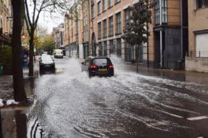 urface water flooding across an urban London street, the kind of local flooding a critical drainage area is mapped to manage.