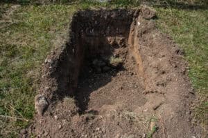 xcavated soakaway trial pit illustrating the question 'do you need infiltration testing' for a planning drainage strategy.