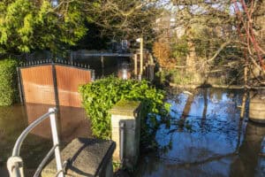 Flooded garden and part-submerged shed, showing existing flooding a betterment planning condition cannot require a developer to fix.
