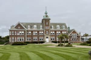 Large period building in open grounds, the kind of property a flood risk assessment for a care home usually covers.