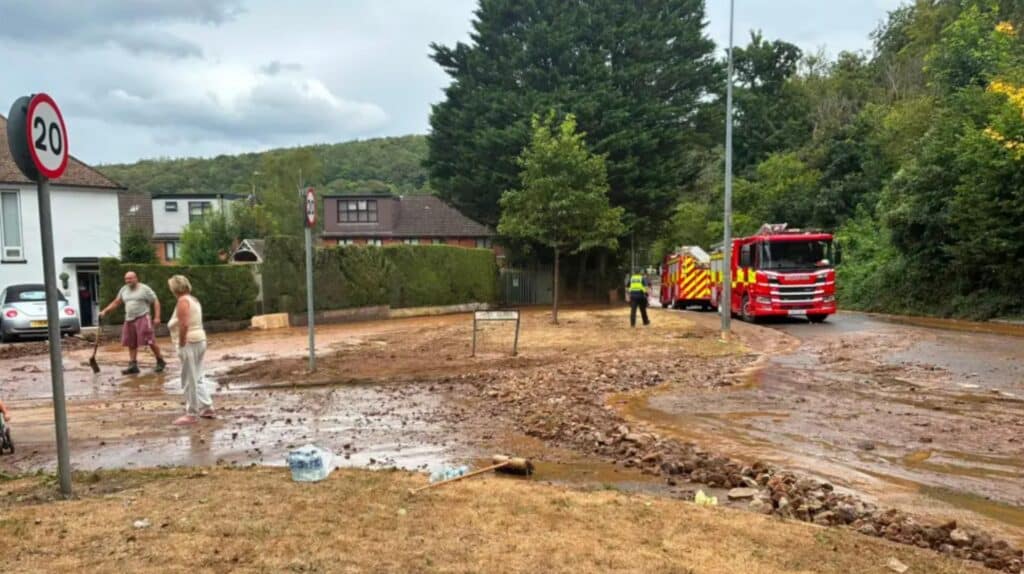 Fire engine and residents clearing mud in Gwaelod-y-Garth, Wales, after the flood behind Unda's quarry flood risk assessment article.