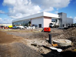 Surface water drainage chamber and pipe under construction on a commercial development, the kind of works a SuDS proforma summarises.