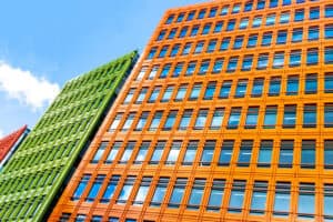 Colourful orange and green office block, the kind of building a flood risk assessment for an office to residential conversion would cover under Class MA.