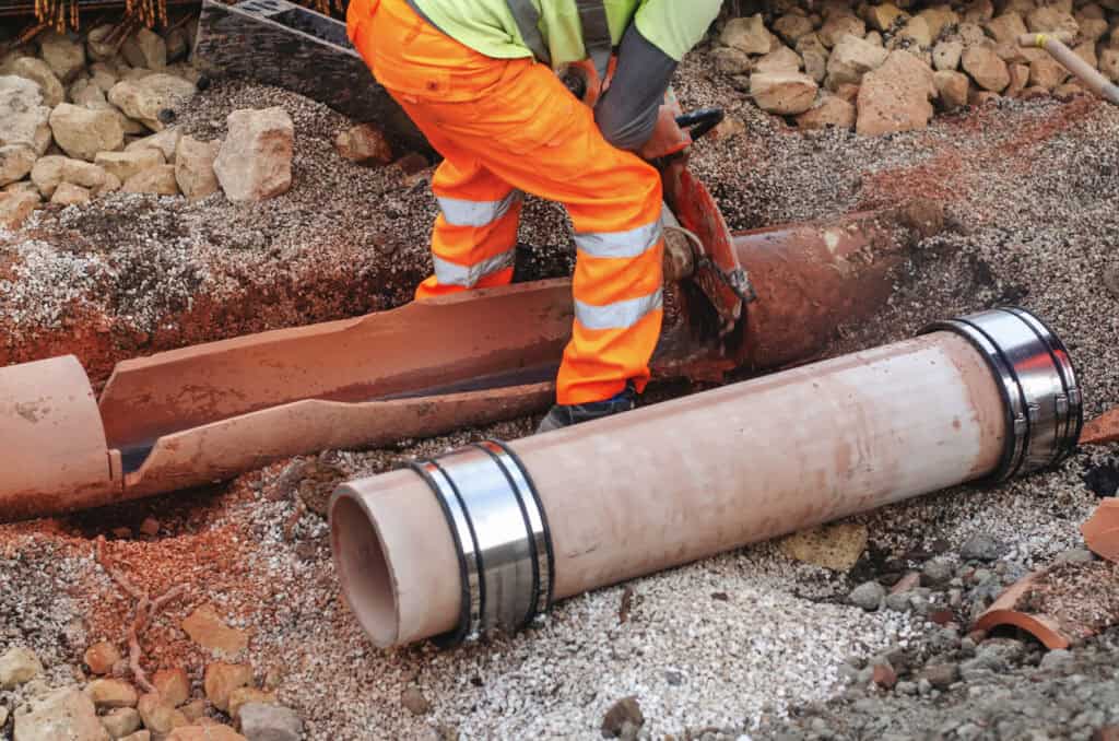 New sewer pipes being laid in a trench, the kind of adoptable network covered by a section 104 agreement.
