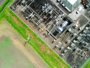 Aerial view of an outdoor electrical substation compound and its fenced perimeter, the subject of a substation flood risk assessment.