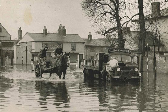 A horse and cart passing a stalled lorry in floodwater at the Abbey Street junction during the 1947 floods.