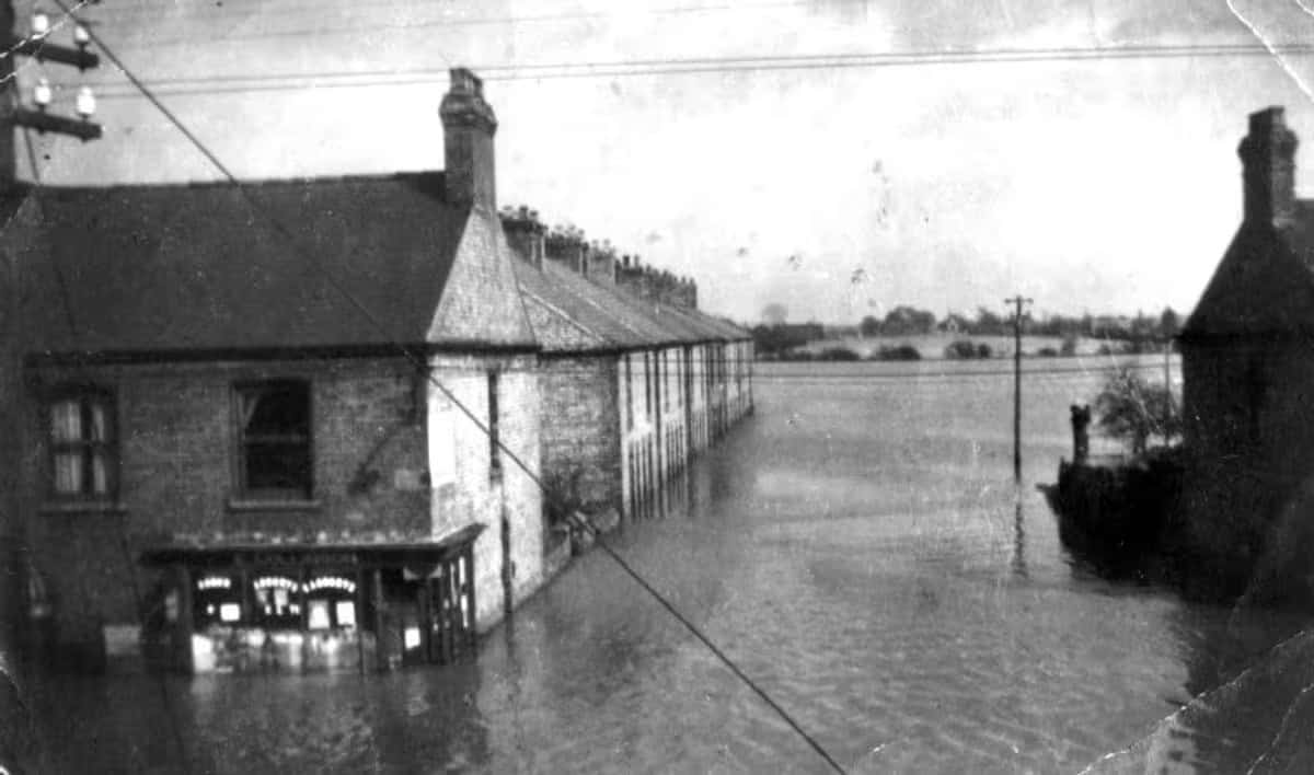 Floodwater from the 1947 floods standing against the cottages and corner shop of Albion Terrace, Misterton.