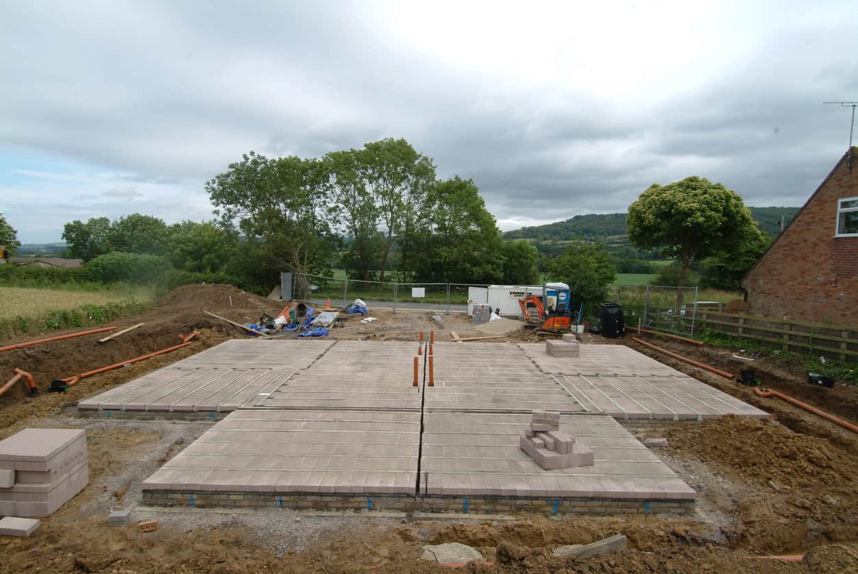 Beam and block ground floor on a new house plot, its level set in metres above Ordnance Datum before screed and finishes.