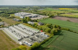 Grid-scale battery storage compound and its own substation seen from the air, the site type a BESS flood risk assessment covers.