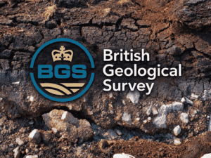 British Geological Survey logo and wordmark set over a photograph of exposed soil, stones and layered ground.