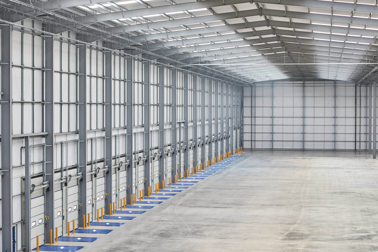 Loading docks in an empty distribution warehouse, like those assessed for a cold store purchase in a Flood Zone 3 pumped fen.