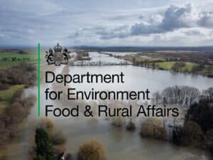 Defra flood risk management graphic: the Department for Environment, Food & Rural Affairs logo over an aerial view of a flooded river floodplain.