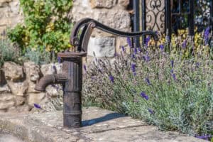 Old cast-iron hand pump, the kind of private water supply that carries a groundwater source protection zone with no mapped extent.