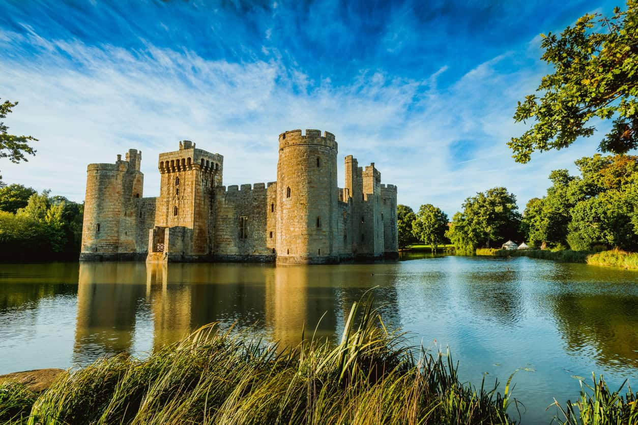 Bodiam Castle reflected in its spring-fed moat, an example of medieval drainage engineering still holding water.
