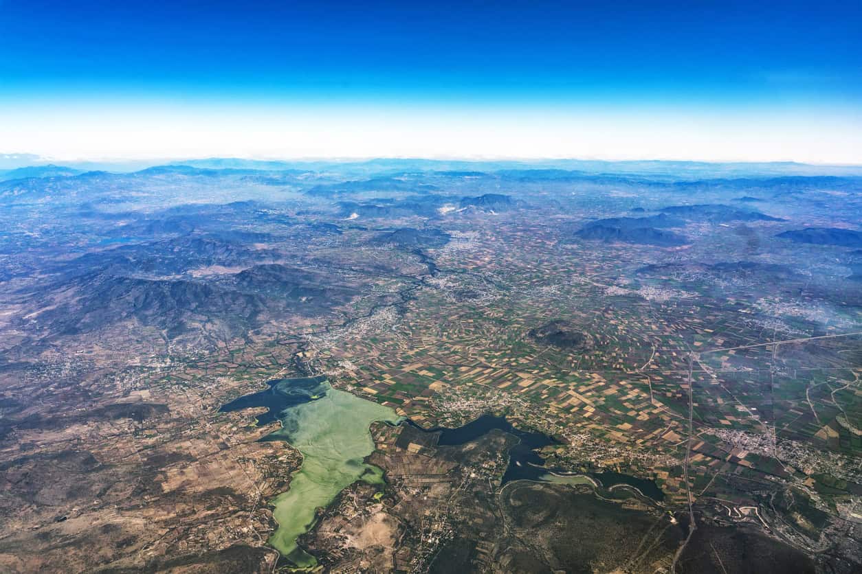 Aerial view of what remains of Lake Texcoco, farmed to the shoreline on the drained floor behind the Mexico City sinking.
