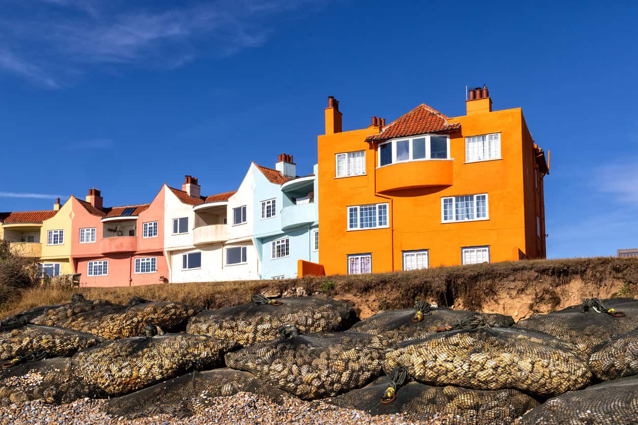 Rock-filled bags on the beach below clifftop houses at Thorpeness, Suffolk, as a temporary defence against coastal erosion.