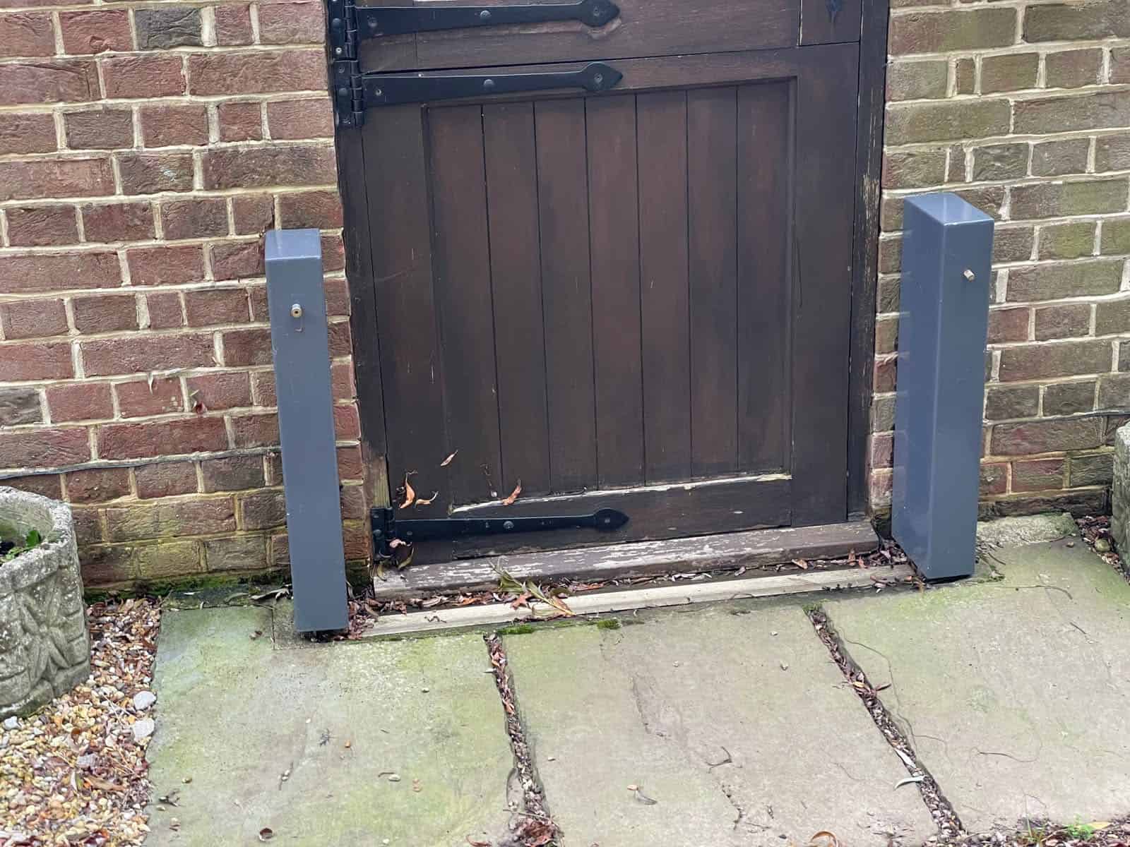 Side posts for a removable door flood barrier fixed beside a timber door, one of the active flood defences for homes.