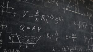 Manning's equation chalked on a blackboard beside Q = AV, the hydraulic radius formula and a trapezoidal channel sketch.