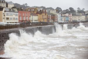 Storm waves breaking against the stone sea wall at Dawlish in Devon, part of the sea defences along the town's seafront.